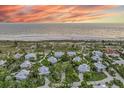 Aerial view of the house, highlighting its location near the beach in a upscale community at 22 Seawatch Dr, Boca Grande, FL 33921