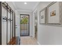 Bright entryway with coat rack, bench, and view to the living area at 5700 Gulf Shores Dr # C157, Boca Grande, FL 33921