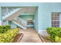 Teal condo building with exterior stairs and landscaping at 19385 Water Oak Dr # L-106, Port Charlotte, FL 33948