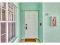 Light teal condo building exterior with white door and window at 19385 Water Oak Dr # L-106, Port Charlotte, FL 33948