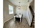 Dining area with white table and four black chairs at 5043 Sunnyside Ln, Bradenton, FL 34211