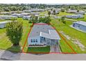 Bird's eye view of a light blue manufactured home and its lot at 5704 Holiday Park Blvd, North Port, FL 34287