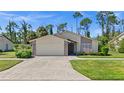 Attractive single-story home with a two-car garage and nicely landscaped yard at 404 Cypress Forest Dr, Englewood, FL 34223