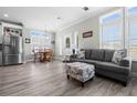 Open living area with gray sofa and dining table at 9085 Pinehaven Way, Englewood, FL 34224
