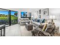 Bright living room with ocean view, comfy sofas, and tasteful decor at 5000 Gasparilla Rd # Bc101, Boca Grande, FL 33921