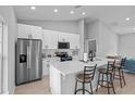 Bright kitchen features a large island with seating and modern appliances at 220 Mark Twain Ln, Rotonda West, FL 33947