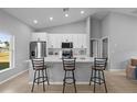 Bright kitchen features a large island with seating, white cabinets and modern appliances at 220 Mark Twain Ln, Rotonda West, FL 33947