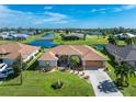 Single-story home with lake view and landscaped yard at 240 White Marsh Ln, Rotonda West, FL 33947