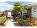 Well-maintained home with attractive landscaping and a paved walkway at 240 White Marsh Ln, Rotonda West, FL 33947