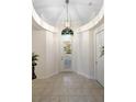 Bright entryway with tiled floors and elegant chandelier at 29 St John Blvd, Englewood, FL 34223