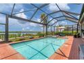 Relaxing screened pool and spa overlooking the water at 15248 Spanish Point Dr, Port Charlotte, FL 33981