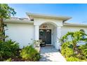 Elegant front entry with double doors and decorative landscaping at 7171 Teaberry St, Englewood, FL 34224