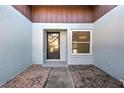 Front entry with a door and a window, tiled flooring at 612 Deerwood Ave # 169, Englewood, FL 34223