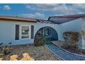 Front entry of a light blue house with a screened porch at 612 Deerwood Ave # 169, Englewood, FL 34223