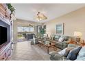 Spacious living room with light-colored sofas and access to a balcony at 13313 Gasparilla Rd # C205, Placida, FL 33946