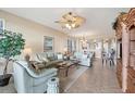Open living room with light teal sofas and a view to the dining room and kitchen at 13313 Gasparilla Rd # C205, Placida, FL 33946