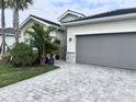 This home boasts an attached two-car garage, complimented by well-manicured landscaping at 19060 Moscato Ct, Venice, FL 34293