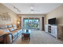 Bright living room with comfy seating, large window and view of patio at 514 Pine Hollow Cir # 514, Englewood, FL 34223
