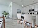 Modern kitchen with white cabinets and quartz countertops at 19060 Moscato Ct, Venice, FL 34293