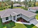 Single-Gathering home with gray exterior and nicely landscaped lawn at 2775 Wyola Ave, North Port, FL 34286