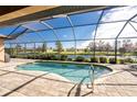 Relaxing pool area with screened enclosure and tranquil water views at 849 Rotonda Cir, Rotonda West, FL 33947