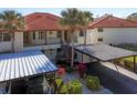 Condo building with carport parking and landscaped grounds at 514 Pine Hollow Cir # 514, Englewood, FL 34223