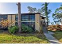 Condo unit with a private screened patio and lush landscaping at 19 Quails Run Blvd # 2, Englewood, FL 34223