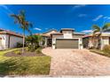 Single-story home with a two-car garage and landscaped front yard at 13077 Rinella St, Venice, FL 34293