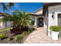 Welcoming entryway with a paved walkway and lush landscaping at 13077 Rinella St, Venice, FL 34293