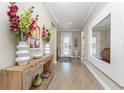Bright and spacious entryway with a large mirror and wooden console table at 13077 Rinella St, Venice, FL 34293
