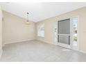 Spacious dining area with tile flooring and a chandelier at 127 Marker Rd, Rotonda West, FL 33947