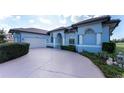 Light blue house with a two-car garage and manicured landscaping at 4130 Cape Haze Dr, Placida, FL 33946