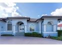 House exterior with arched entryway, columns and neatly trimmed hedges at 4130 Cape Haze Dr, Placida, FL 33946