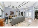 Spacious living room with gray sofa, ceiling fan, and tile flooring at 4130 Cape Haze Dr, Placida, FL 33946