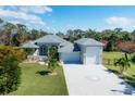 House with a large driveway and a detached garage at 124 Cutlass Dr, Rotonda West, FL 33947