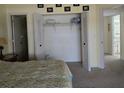 Bedroom with a walk-in closet and carpeting at 26 Quails Run Blvd # 7, Englewood, FL 34223