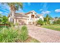 One-story house with a brick driveway and lush landscaping at 13033 N Marsh Dr, Port Charlotte, FL 33953