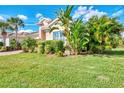 Lush tropical landscaping around a one-story house at 13033 N Marsh Dr, Port Charlotte, FL 33953