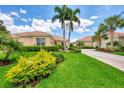 Single story home with tile roof, attached garage, and manicured landscaping at 2844 Myakka Creek Ct, Port Charlotte, FL 33953