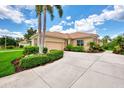 Single story home with tile roof and attached garage, beautiful landscaping at 2844 Myakka Creek Ct, Port Charlotte, FL 33953