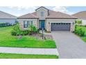 One-story home with tile roof and stone accents at 10985 Trevino St, Englewood, FL 34223