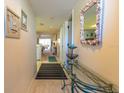 Bright entryway with glass-top table, mirror, and view into living area at 6800 Placida Rd # 192, Englewood, FL 34224