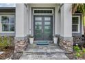 Grand entryway with double doors and stone accents at 71 Pine Valley Pl, Rotonda West, FL 33947