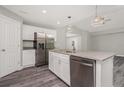 Modern kitchen with island and stainless steel appliances at 148 Lime Tree Park, Rotonda West, FL 33947