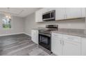 Modern kitchen with stainless steel appliances at 148 Lime Tree Park, Rotonda West, FL 33947