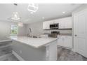 Modern kitchen with white cabinets, granite countertops, and stainless steel appliances at 450 Albatross Rd, Rotonda West, FL 33947