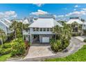 Bright white beach house with metal roof and paver driveway at 5000 Gasparilla Rd # 41, Boca Grande, FL 33921