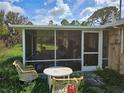 Small screened porch with table and chairs, needs some cleaning at 11290 6Th Ave, Punta Gorda, FL 33955