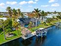Aerial view of waterfront home with private pool and boat dock at 15490 Mccomb Cir, Port Charlotte, FL 33981