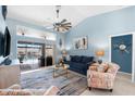 Spacious living room featuring a comfortable seating area and access to a pool view at 15490 Mccomb Cir, Port Charlotte, FL 33981